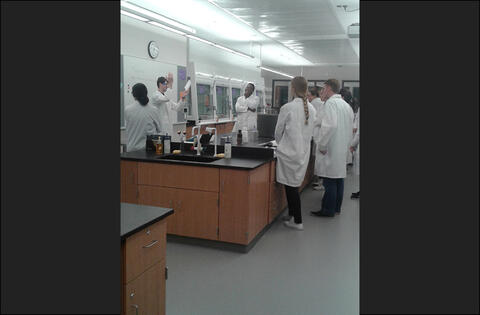 Group of students standing in a large lab